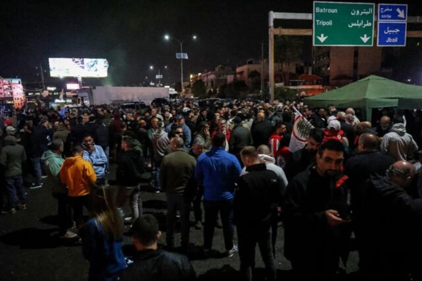 Supporters of the Lebanese Forces block the main Byblos-Beirut highway in protest at the a