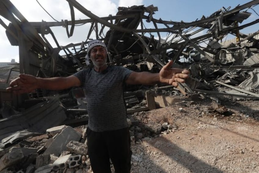 A man inspects the damage from an Israeli air strike, which the Lebanese health ministry s