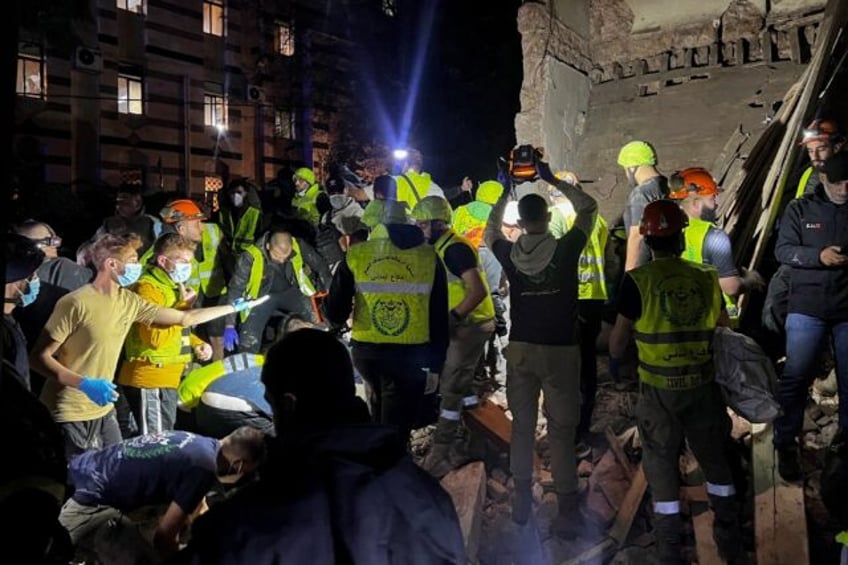 Emergency teams at the site of an Israeli strike on Beirut's Zuqaq al-Blat neighbourhood