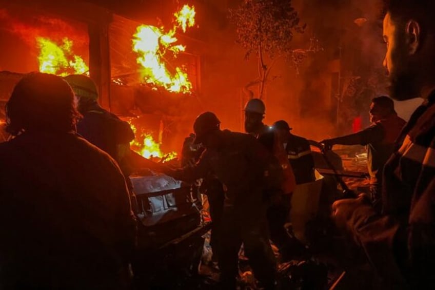 Emergency services fight flames at the site of the Israeli strike on central Beirut