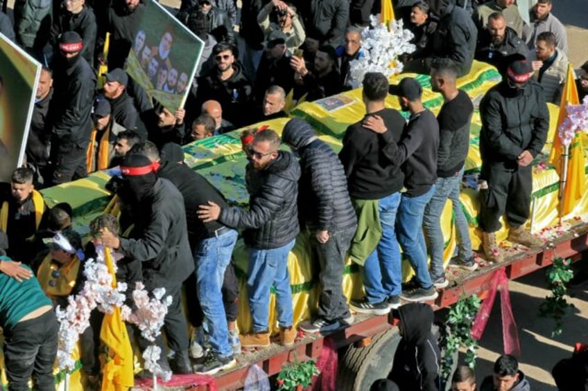 In the heavily damaged town square of Airaroun, southern Lebanon, the coffins arrived on f