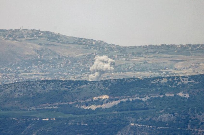 A picture taken from the northern Israeli border with Lebanon shows smoke billowing during