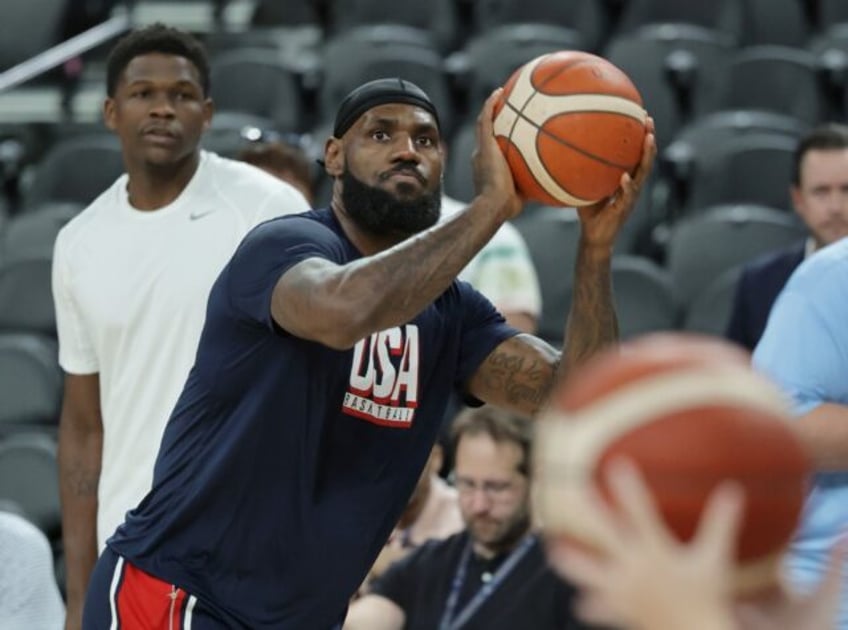 LeBron James warms up under the gaze of team-mate Anthony Edwards before the USA's victory