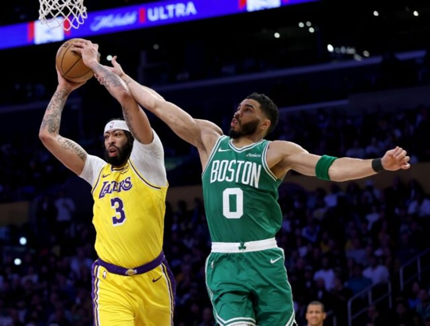 Anthony Davis (left) and Jayson Tatum (right) battle for possession in the Los Angeles Lak