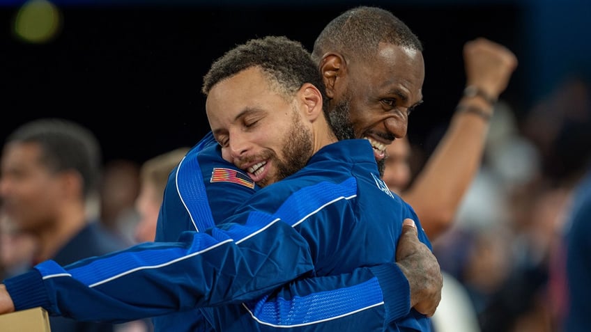 LeBron James embraces Steph Curry