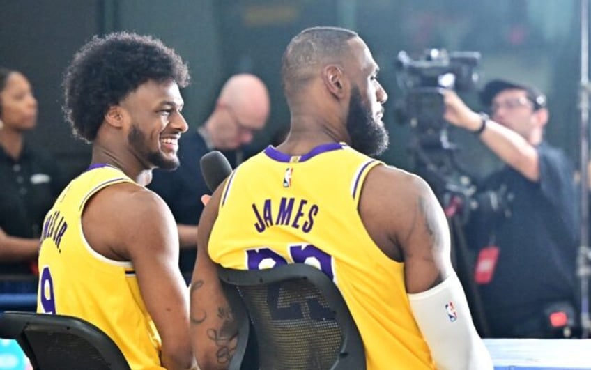 LeBron James (right) gives a television interview alongside son Bronny (left) at the Los A