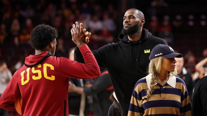 Bronny James does handshake with father, LeBron James