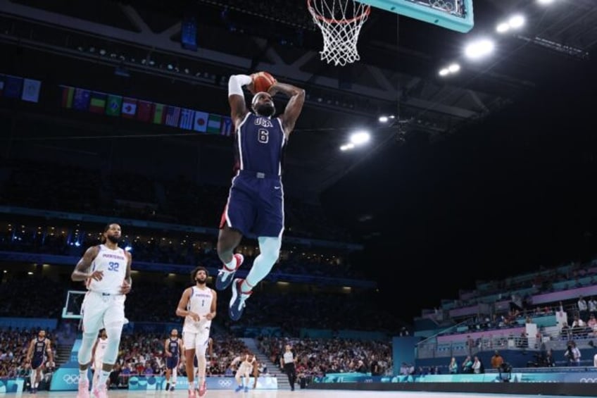 Team USA superstar LeBron James throws down a dunk in a victory over Puerto Rico in group