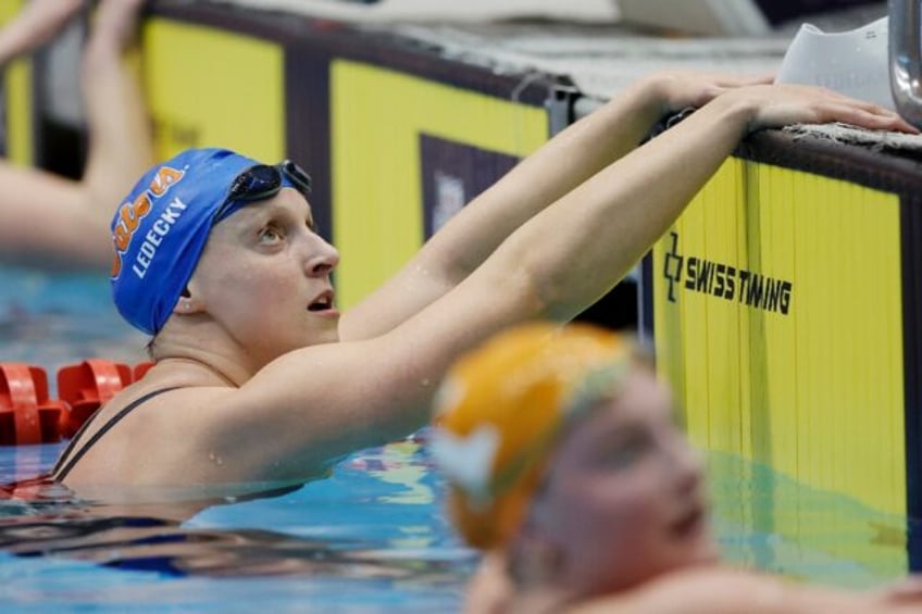 American Katie Ledecky checks the scoreboard after a dominant victory in the women's 1,500m freestyle at the Pro Swim series meeting in Knoxville, Tennessee