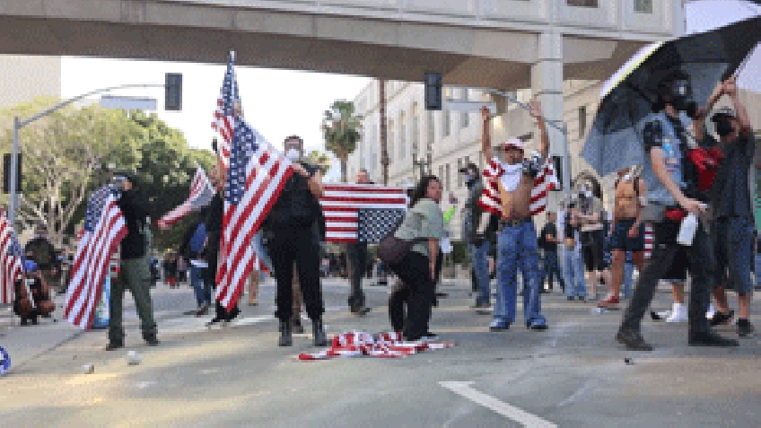 Protesters in Los Angeles seen taunting camera and waving American flags