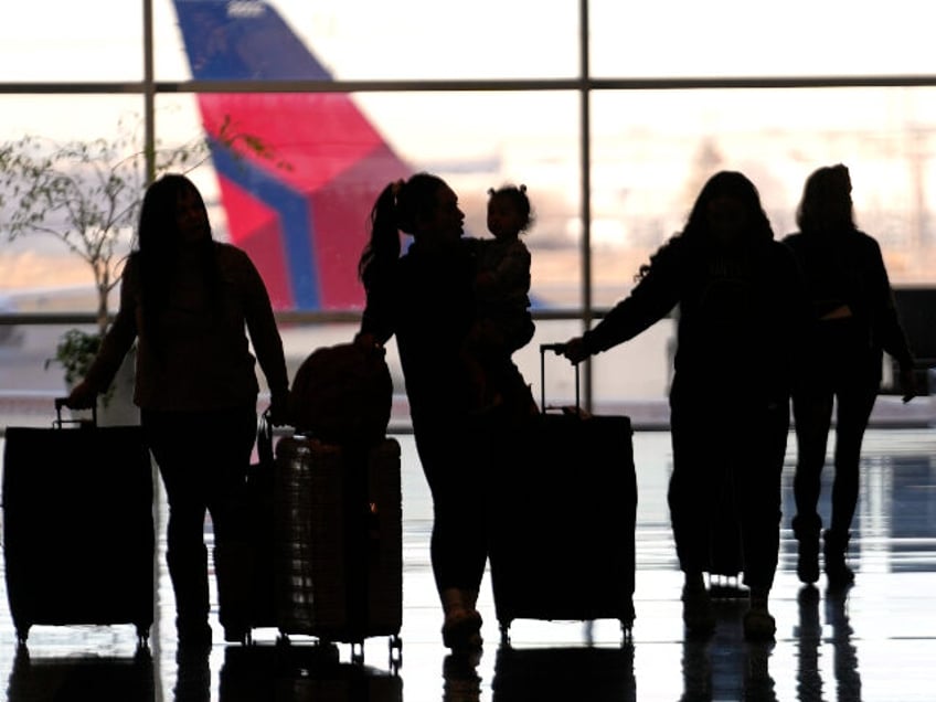 People pass through Salt Lake City International Airport, Wednesday, Jan. 11, 2023, in Sal