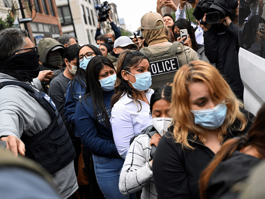 CHICAGO, ILLINOIS - JUNE 4: Immigrants detained by Federal Agents are put into a van outsi