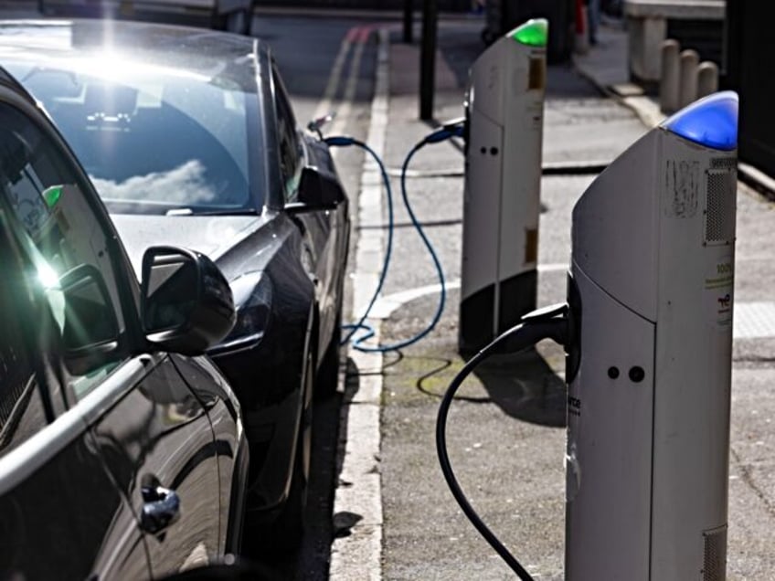 Electric vehicles plugged in at a Source charging point in London, UK, on Friday, Sept. 22, 2023. UK Prime Minister Rishi Sunak said in a speech that he would push back by five years to 2035 a plan to bar the sale of new petrol and diesel cars, casting the …