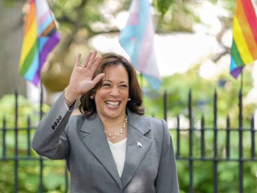 Vice President Kamala Harris, right, waves at supporters who gathered to see her while spe