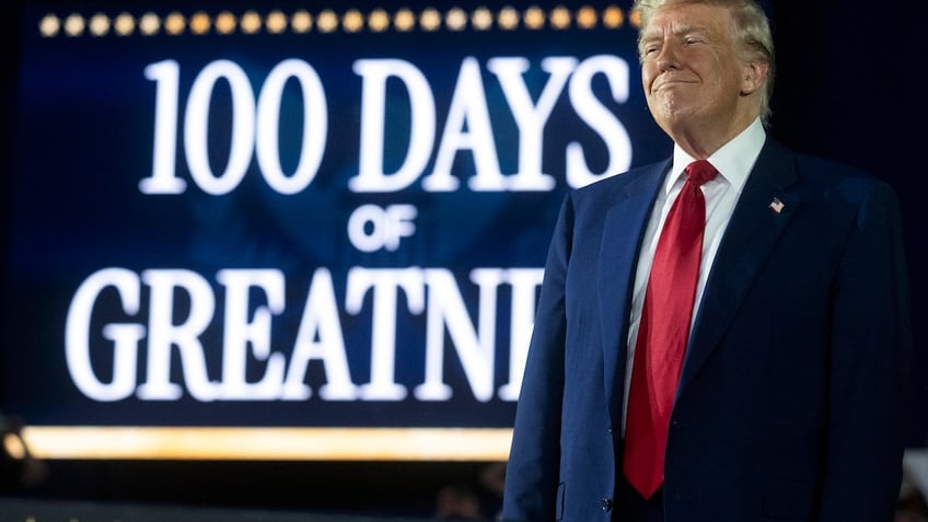 US President Donald Trump delivers a speech marking his 100th day in office at Macomb County Community College Sports Expo Center in Warren, Michigan, on April 29, 2025. Trump celebrated the first 100 days of what is already one of the most radical and far-reaching presidencies in US history, but polls show Americans becoming disenchanted with the economic and political tumult. (Photo by Jim WATSON / AFP)