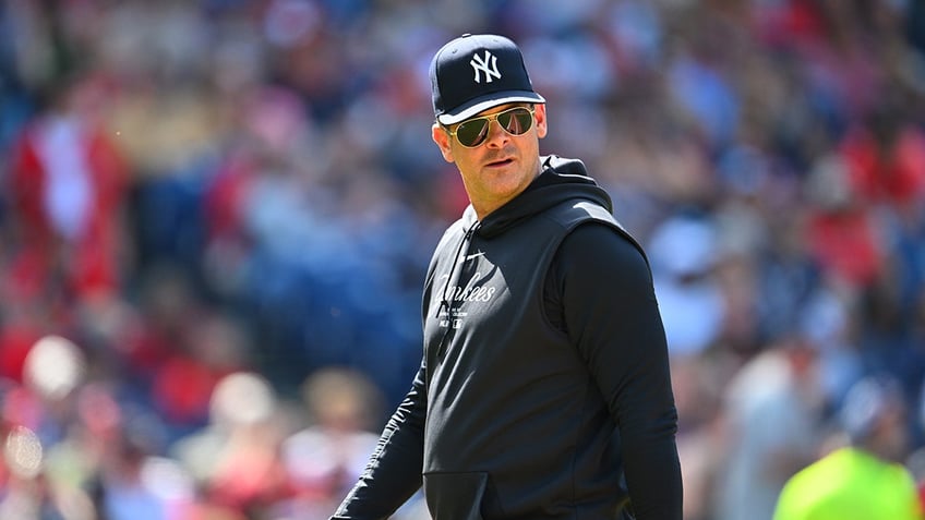 New York Yankees manager Aaron Boone walks back to the dugout after a pitching change during the fifth inning against the Cleveland Guardians at Progressive Field on April 14, 2024 in Cleveland.