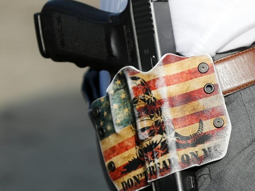 A Dayton Police detective wears his sidearm in a holster bearing the phrase "DON'T TREAD O