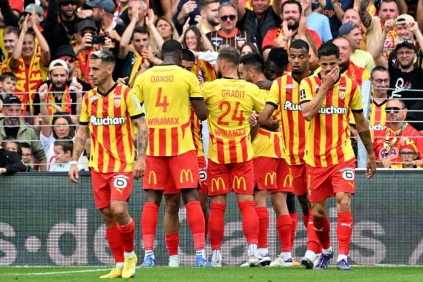 Lens players celebrate the first goal of their 2-0 win against Brest