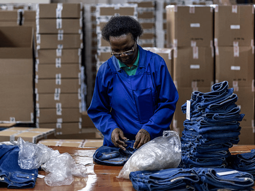 A worker folds completed jeans at the Afri-Expo Textile Factory in Maseru, Lesotho on Marc