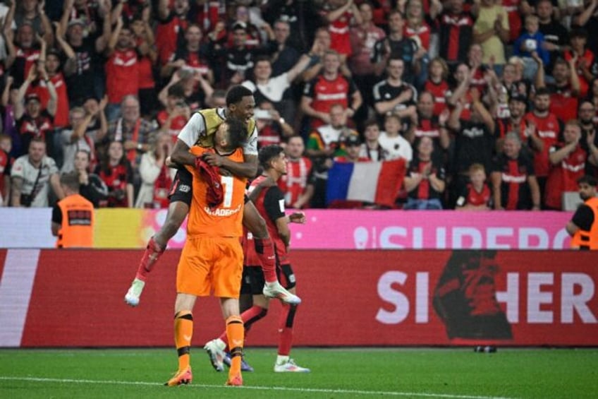 Winning start: Bayer Leverkusen's players celebrate with goalkeeper Lukas Hradecky