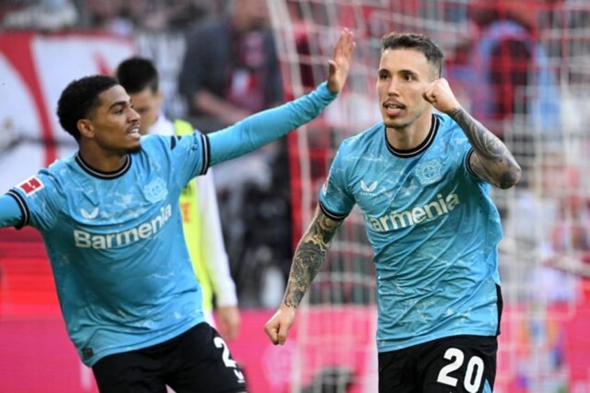 Bayer Leverkusen scorer Alejandro Grimaldo (R) celebrates with Amine Adli