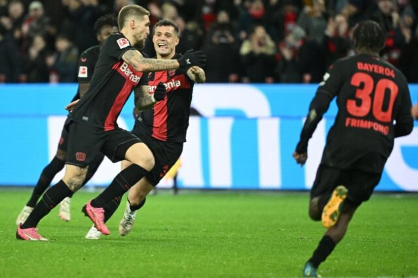 Record breaking: Bayer Leverkusen's Robert Andrich (left) celebrates scoring the winner on