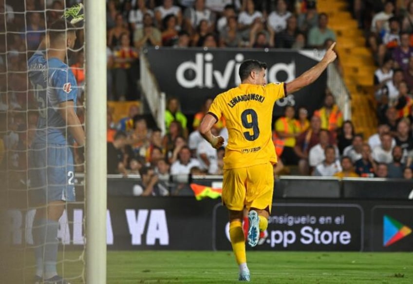 Barcelona's Polish forward Robert Lewandowski netted twice in the win over Valencia on Sat