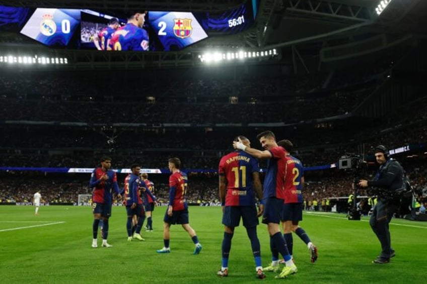 At the double: Barcelona's Polish forward Robert Lewandowski (C) celebrates scoring his te