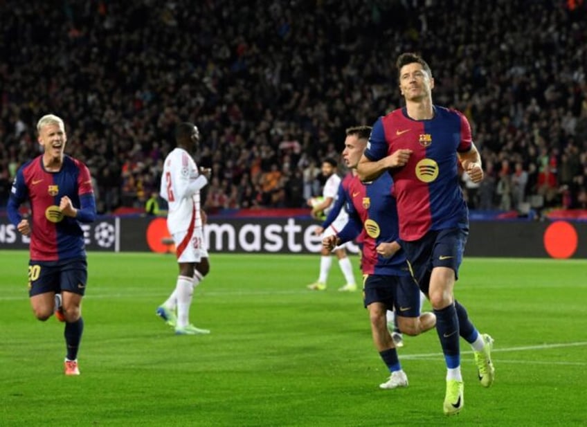 Barcelona's Polish forward Robert Lewandowski (R) reached his Champions League century aga