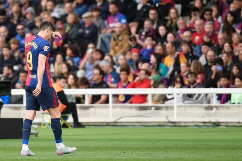 Barcelona's Polish forward Robert Lewandowski leaves the pitch injured against Celta Vigo