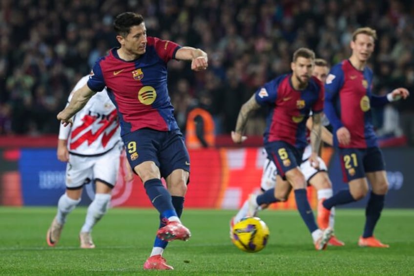 Robert Lewandowski converts the penalty that gave Barcelona victory over Rayo Vallecano an