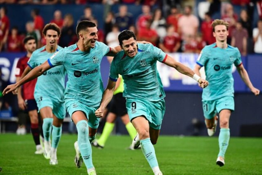 lewandowski penalty earns barca tight win at osasuna