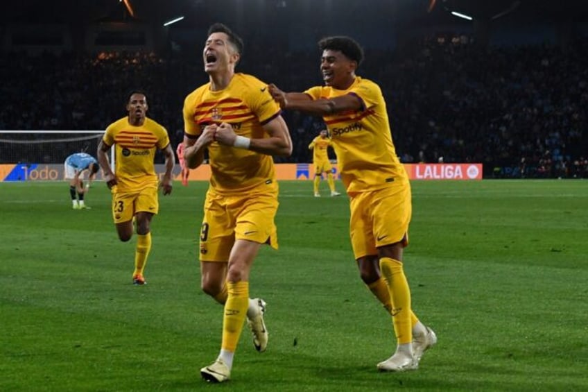 Robert Lewandowski celebrates with Lamine Yamal as Barcelona snatched a 2-1 win at Celta V