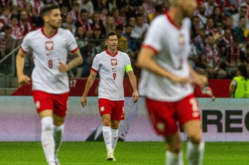 Robert Lewandowski (C) made his Poland debut in 2008