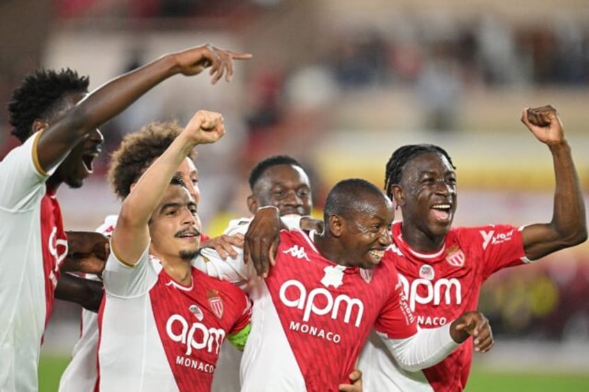 Monaco's Malian midfielder Mohamed Camara (2R) taped over an anti-homophobia logo in their