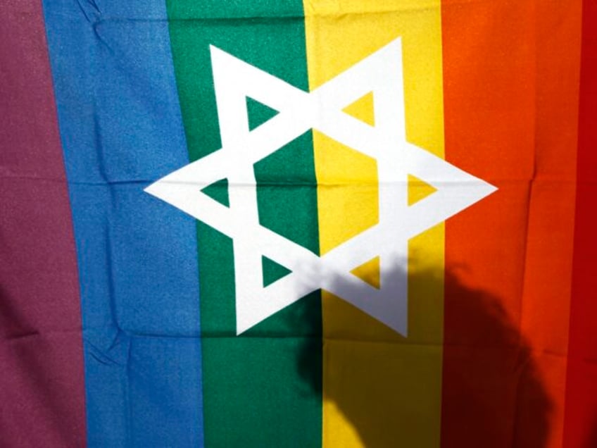 FILE - In this file photo taken on June 25, 2009, an Israeli man walks behind a pride flag