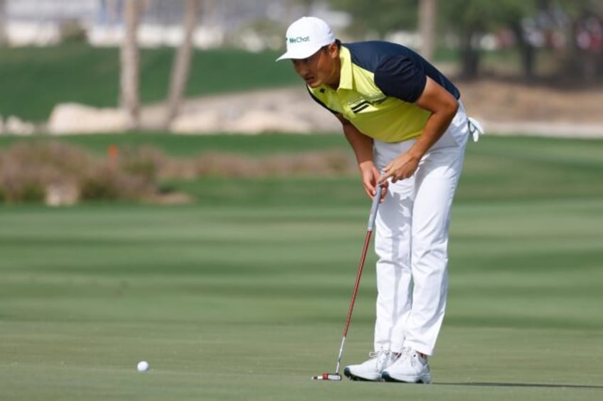 Li Haotong lines up a final-round putt on his way to victory in the Qatar Masters