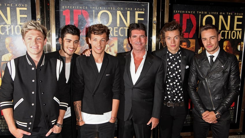 Simon Cowell with the members of One Direction