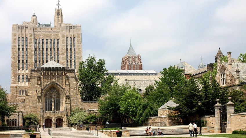 "New Haven, Connecticut, USA - June 1, 2011: A view of the Yale campus, with the entrance to the renowned Sterling Library at the left. This is one of the largest research libraries in the United States, and is noted for its gothic revival architecture."