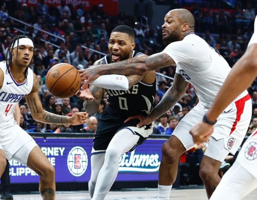 Milwaukee's Damian Lillard controls the ball against P.J. Tucker of the LA Clippers in the