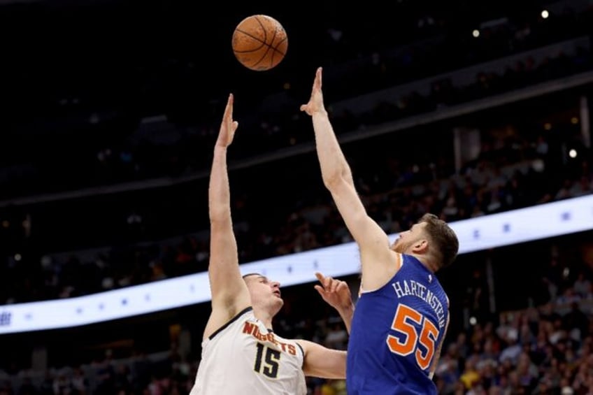 Nikola Jokic of the Denver Nuggets puts up a shot over Isaiah Hartenstein in an NBA victor