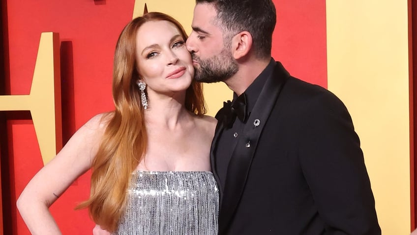 Lindsay Lohan's husband Bader Shammas kisses her on the cheek