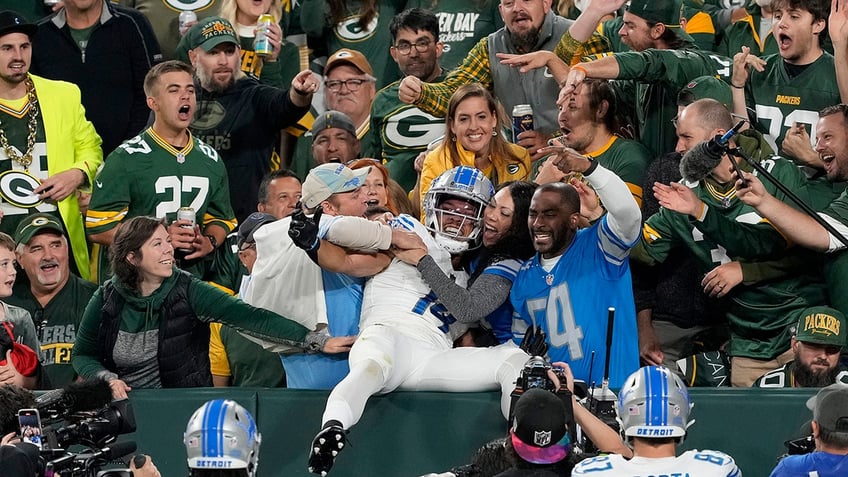 lions amon ra st brown met with beer shower upon lambeau leap