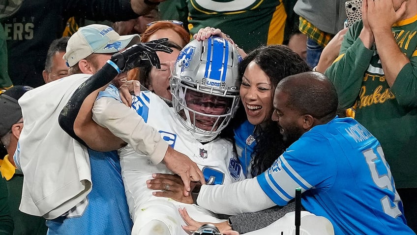 lions amon ra st brown met with beer shower upon lambeau leap