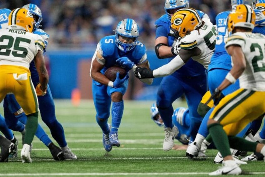 David Montgomery of the Detroit Lions runs for a first down in the Lions' NFL victory over