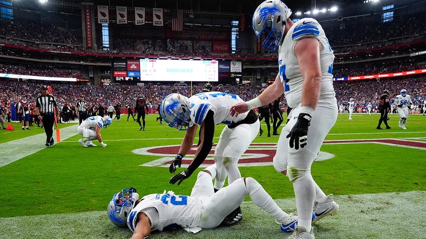 Jahmyr Gibbs lies in end zone