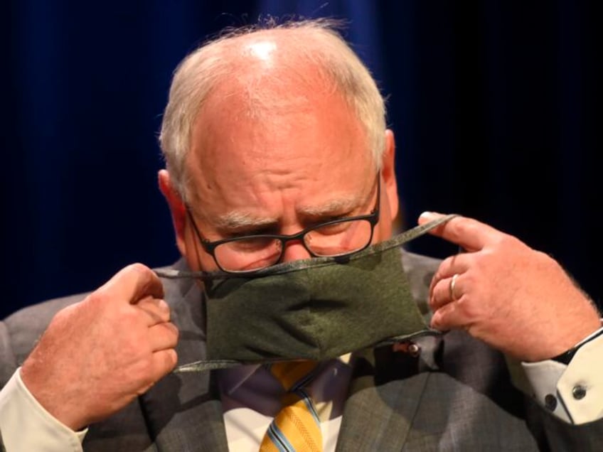 Minnesota Gov. Tim Walz put his face mask at the conclusion of a press conference Thursday