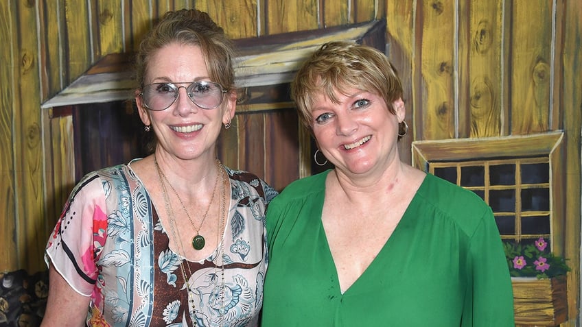 Melissa Gilbert and Alison Arngrim standing next to each other and smiling