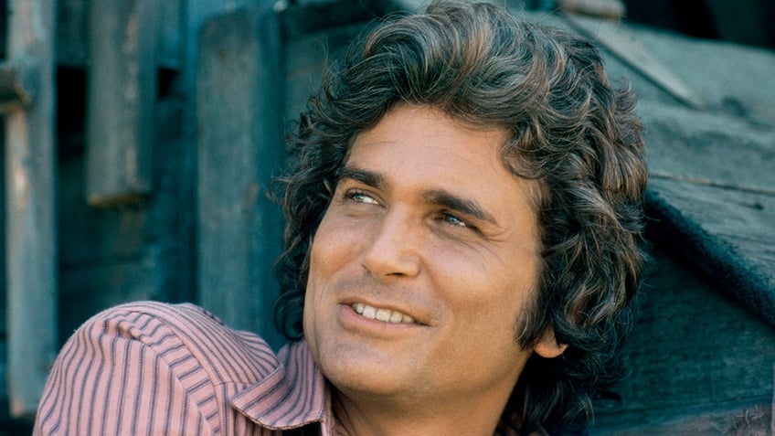 A close-up of Michael Landon smiling and looking to the distance