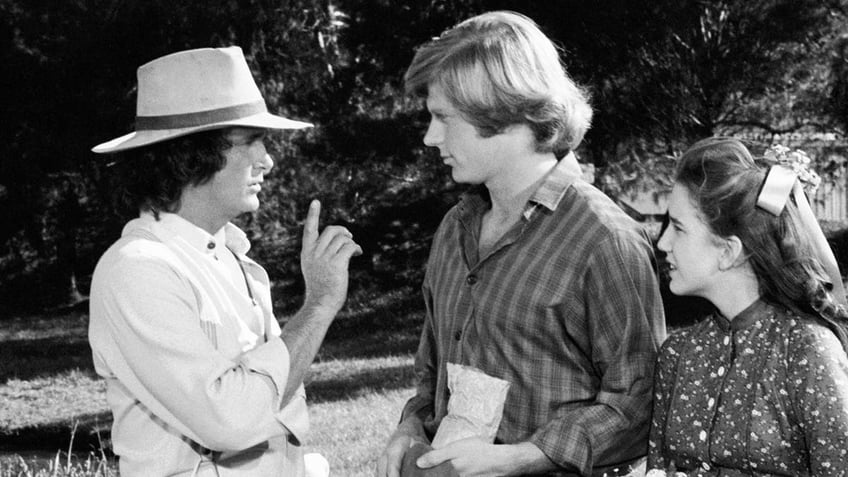 Michael Landon directing Dean Butler as Melissa Gilbert watches.